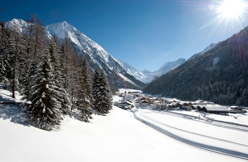 Ötztal, Gries in Längenfeld, Ortsaufnahme, Ortsbild, Winter, Dorf, Häuser, Kirche, Bäume, Wald, Berge, blauer Himmel, Schnee, Sonnenstrahlen